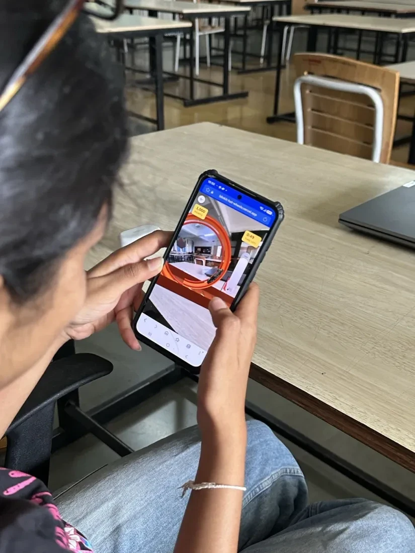 A collector racing the AR prototype on their phone at a desk