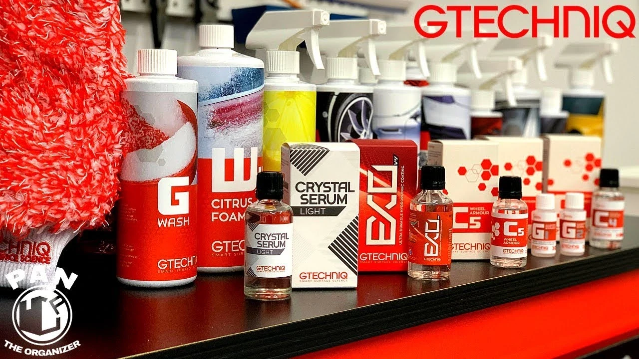 Wide shot of various Gtechniq detailing products including GWash, Citrus Foam, Crystal Serum, EXO, C5, and more arranged on a shelf. Showcases the brand’s full range of car care solutions for cleaning, protection, and enhancement.