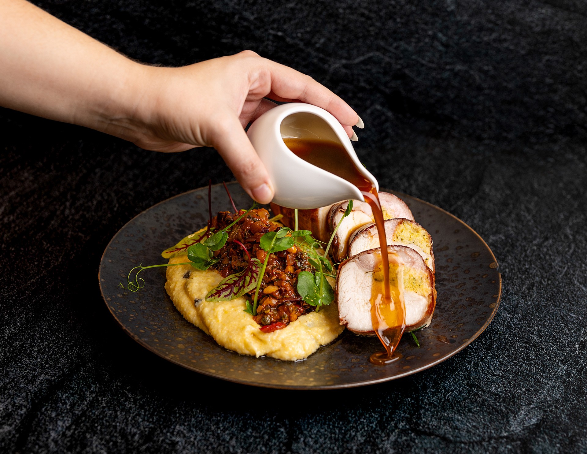 Shared Dining Chicken Roulade with Jus being poured over