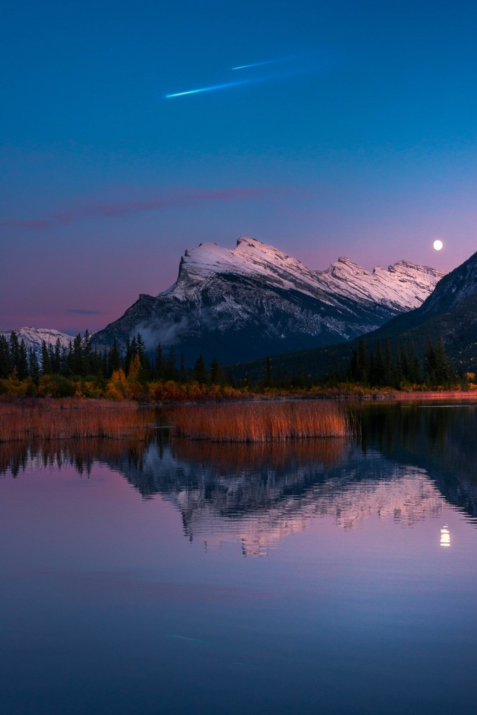 A mountain next to a lake