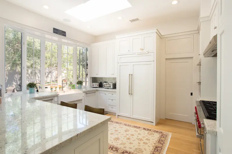 Bright and spacious kitchen with large area run atop hardwood floors from the Big Canyon Remodel project. Photo by Chris Darnall.