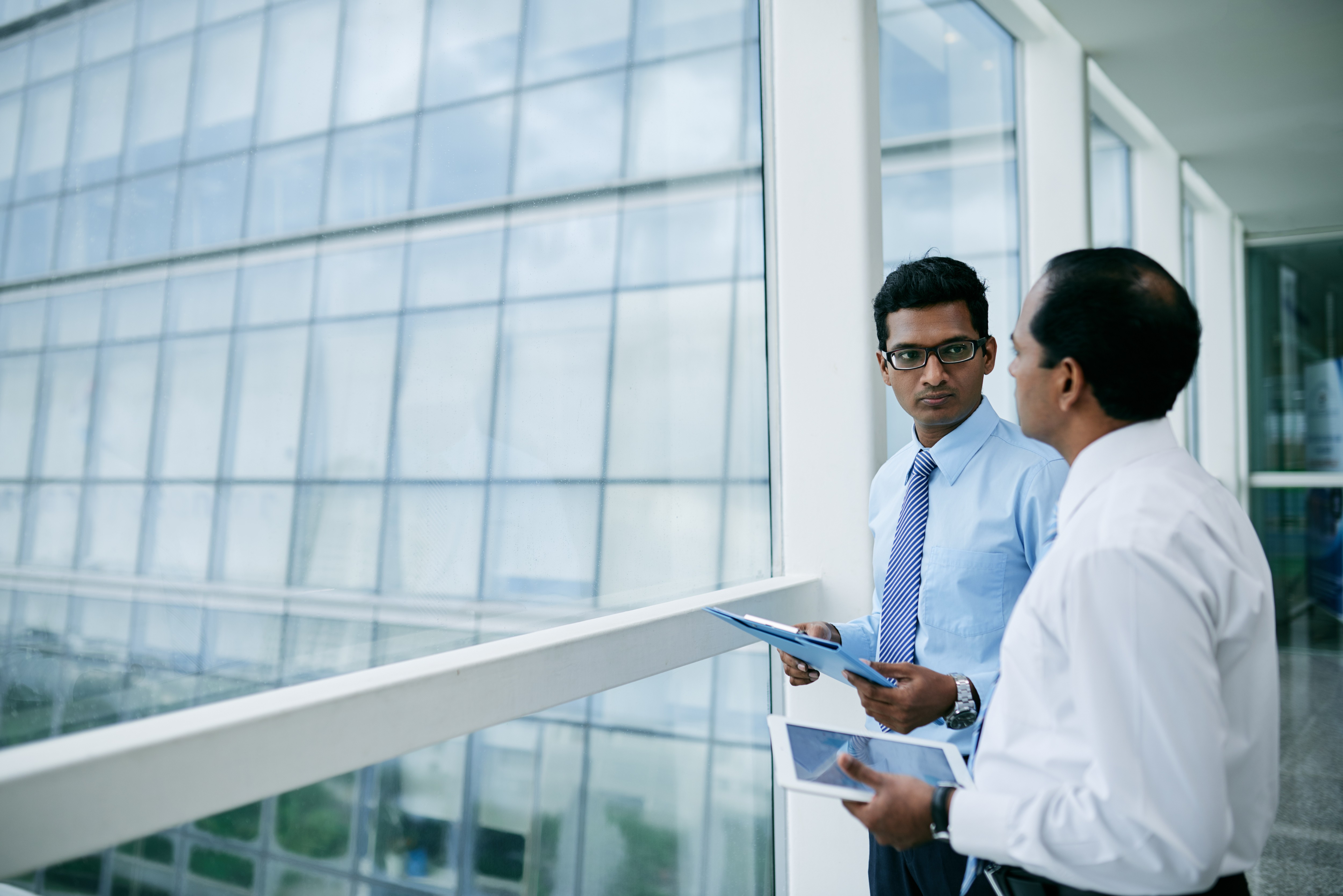 Business continuity manager discussing preparedness with an operational colleague, representing organisational resilience and continuity planning ahead of disruption.