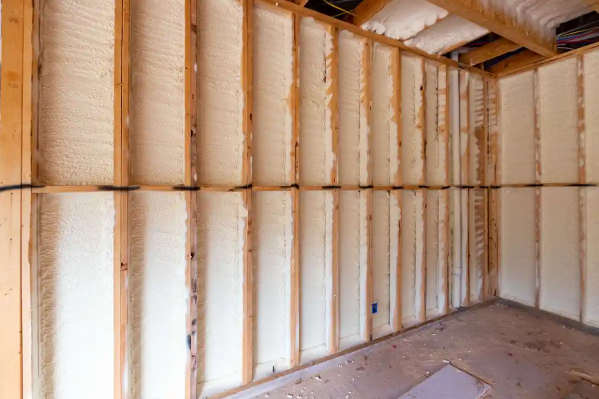 Basement wall insulated with spray foam