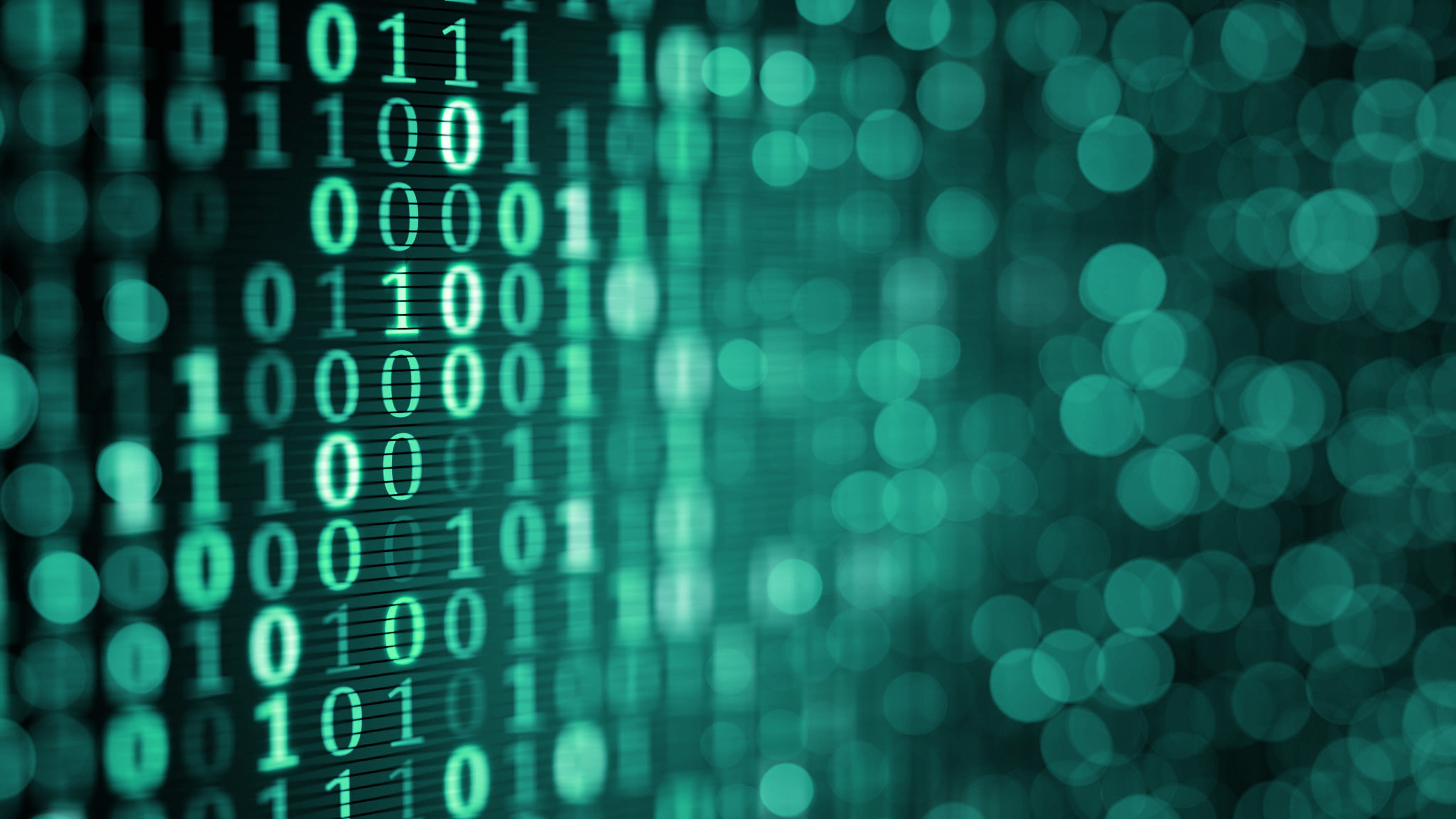 Silhouette of a researcher examining a slide under a microscope with a blue background.