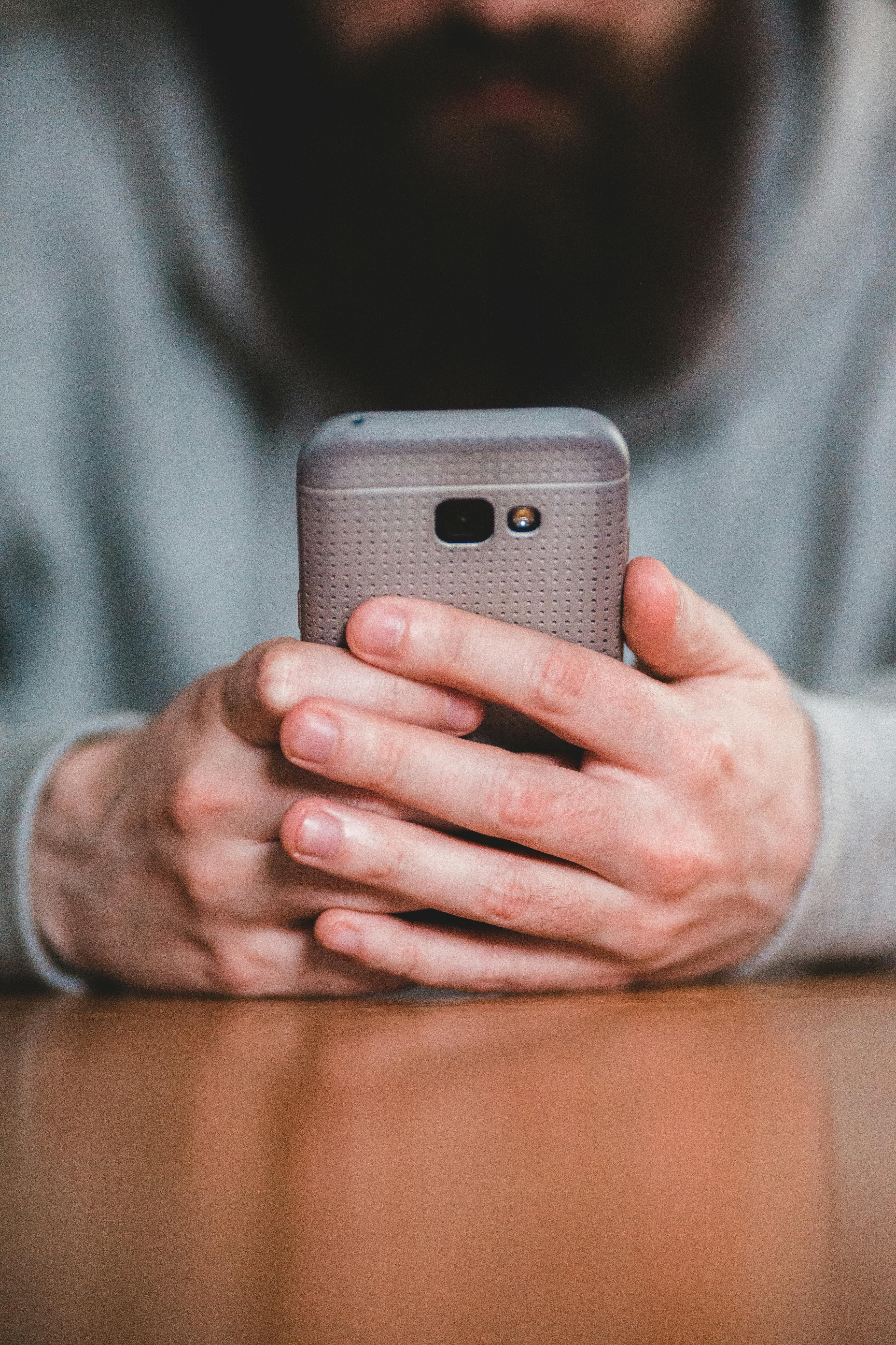A smiling woman doctor is sitting at her desk and looking at a computer screen showing a medical screening test.