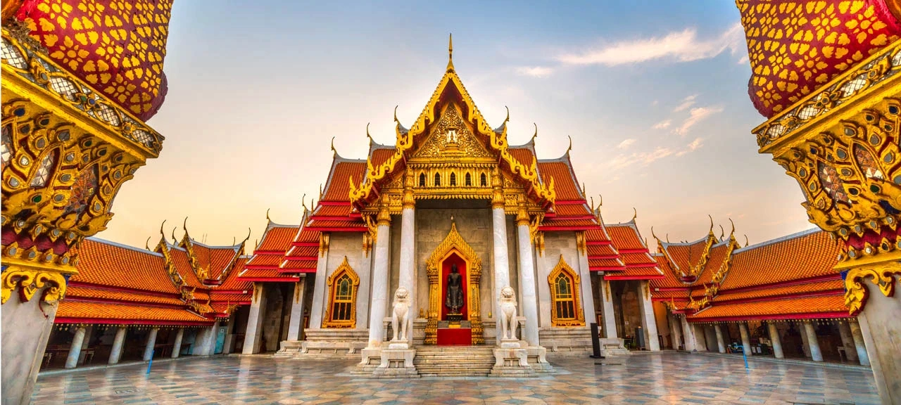 Giant gold Buddha statue outdoors.