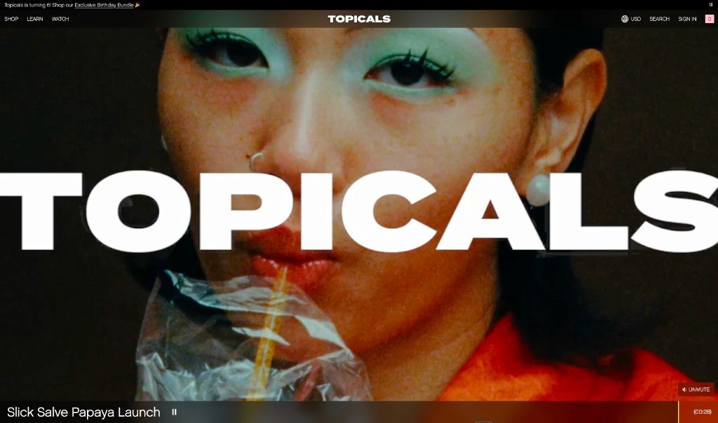 Topicals Watch page with full-screen editorial video for Slick Salve Papaya launch
