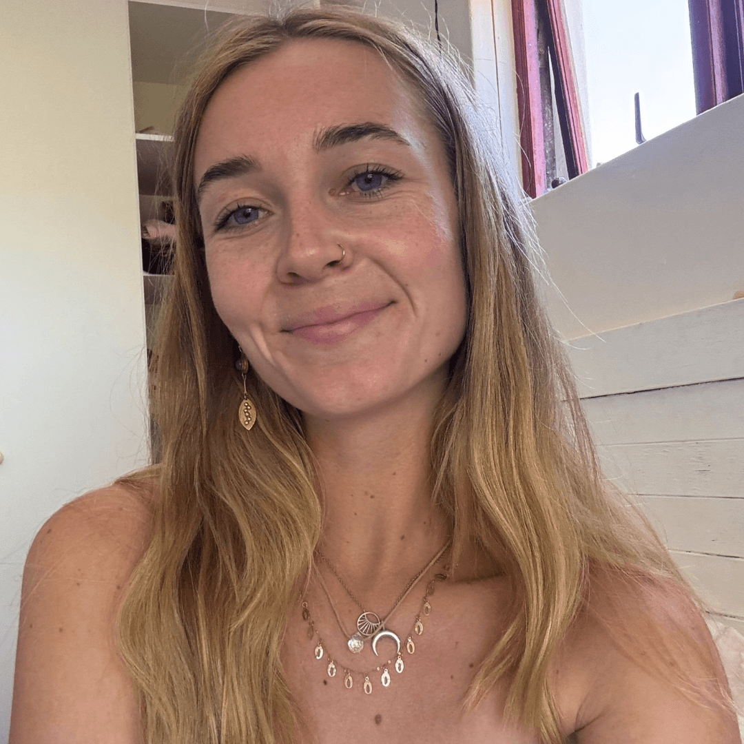 Kathi, a SaunaHaüs facilitator, smiling indoors with gentle natural light.