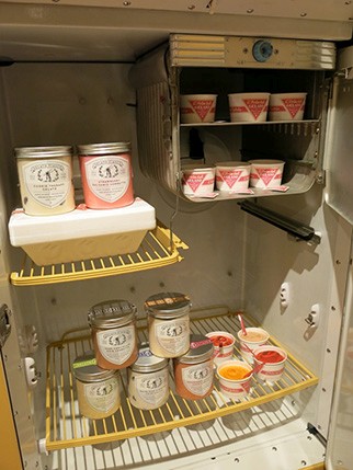 fridge shelves with different cans and products