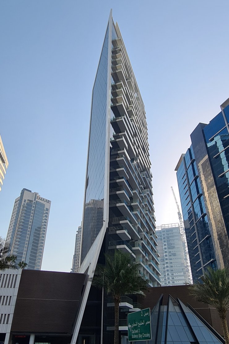 Unique building architecture against the city skyline. Find your next home with our expert real estate consultation.