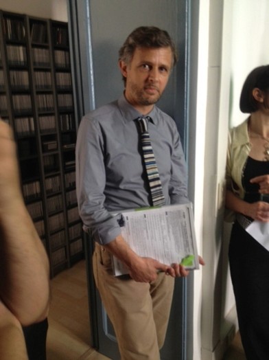 man with tie in front of door