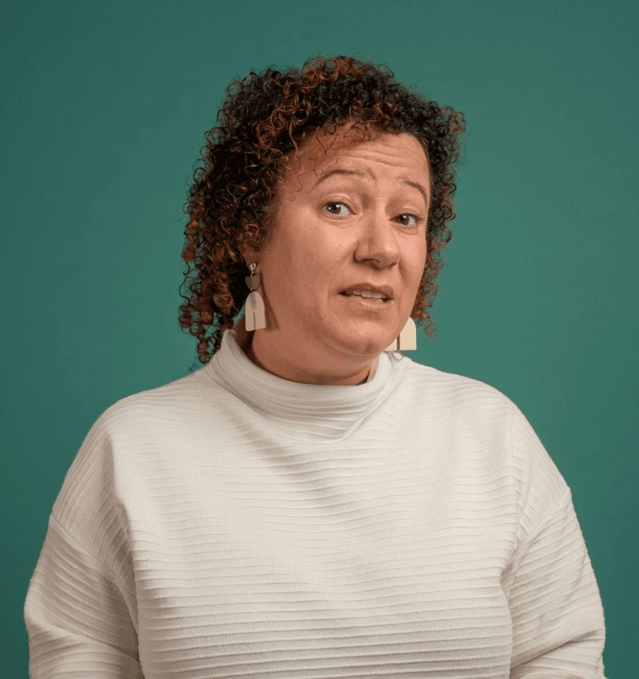 smiling woman sitting on grass during daytime