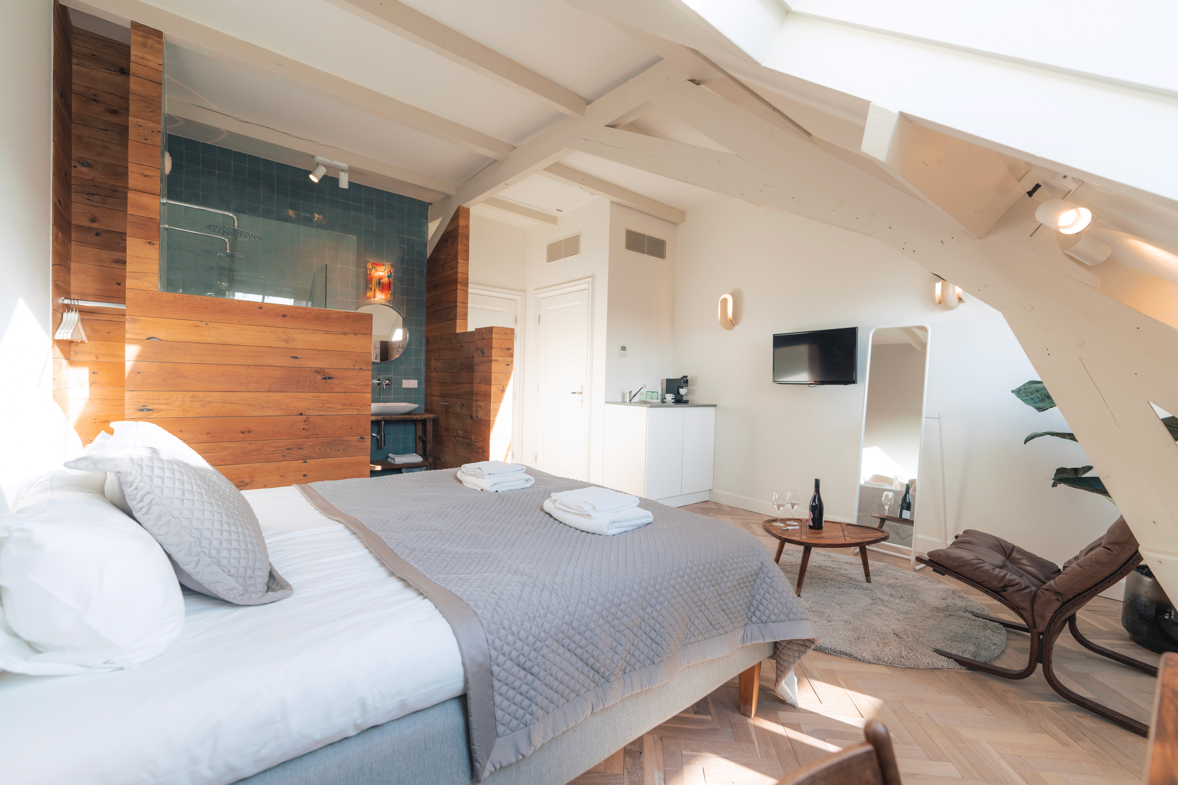 lounge room with large contemporary lamp, cozy sofa and blue toned painting of Venice