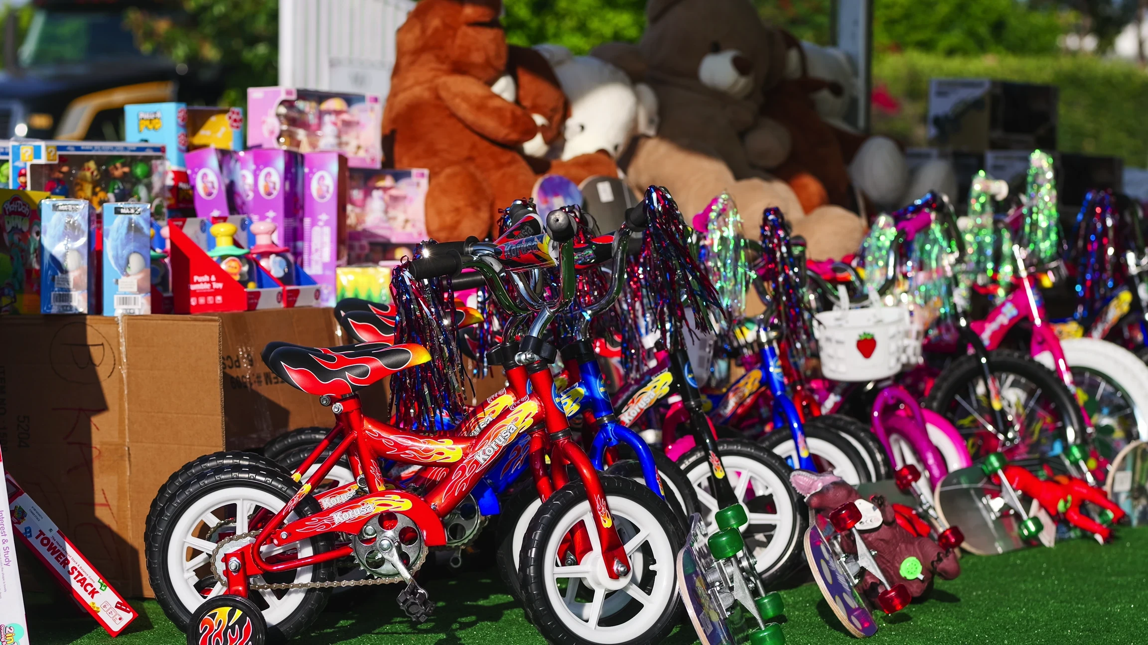 Row of donated bikes and table of donated toys