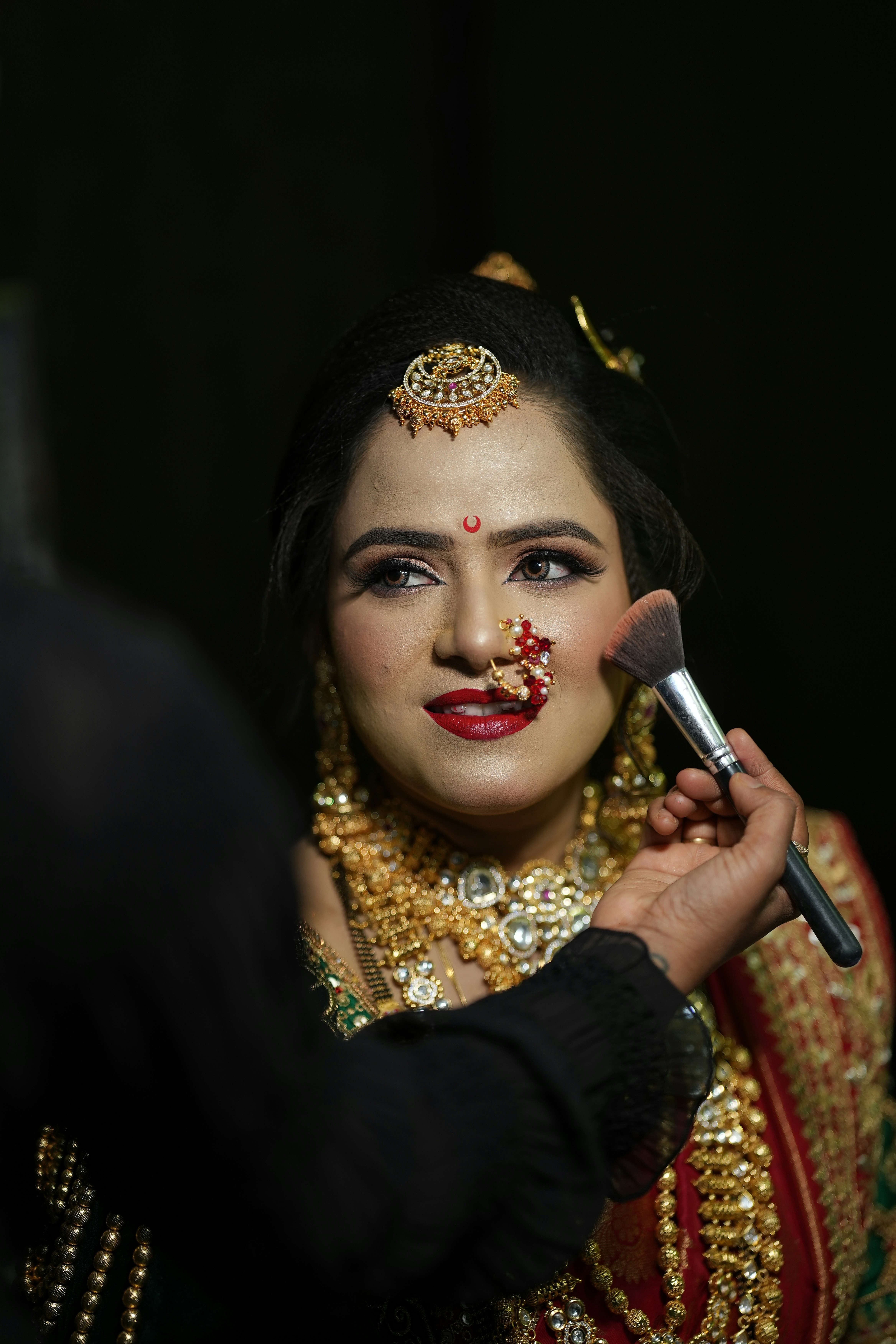 a woman with makeup on her face getting her make - up done