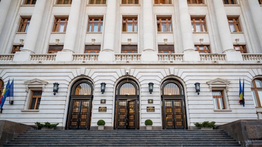 Facade of a building featuring three large arched doors and decorative architectural details.
