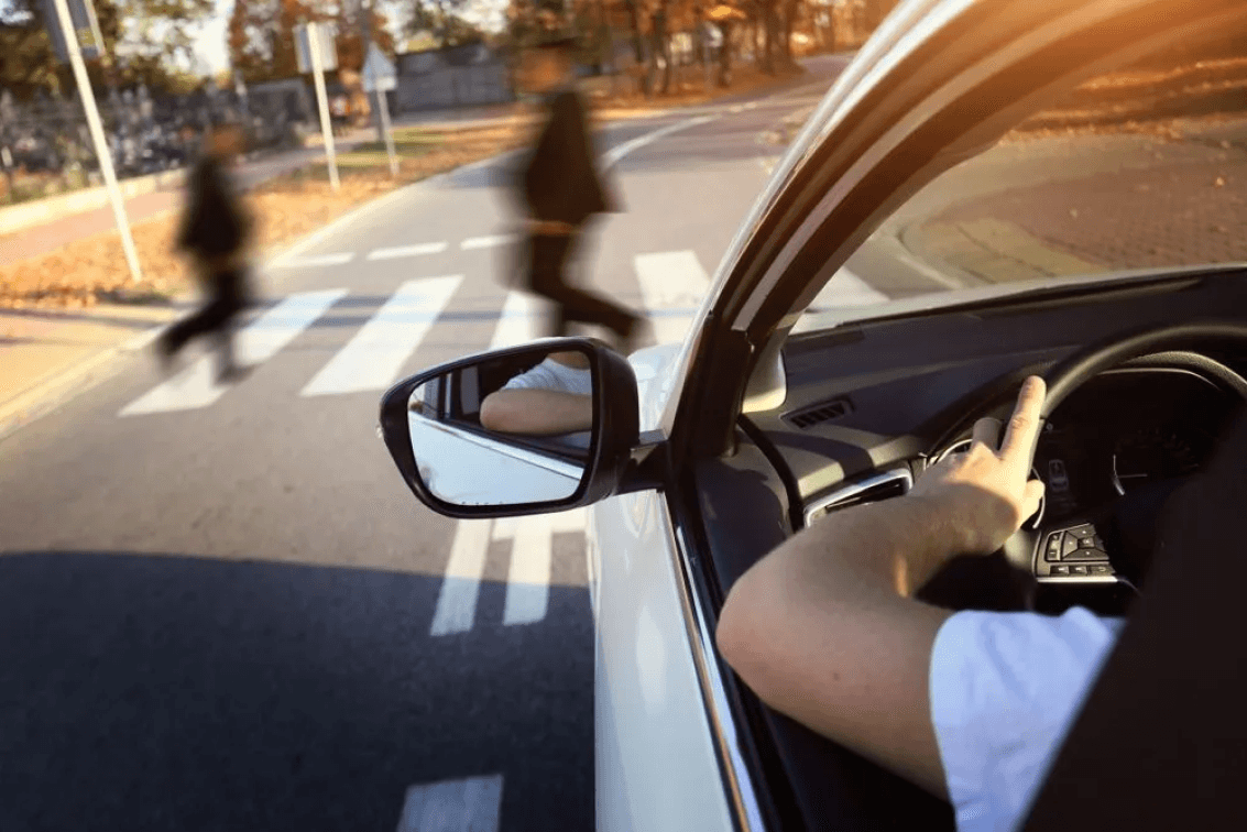 car driving about to hit pedestrians