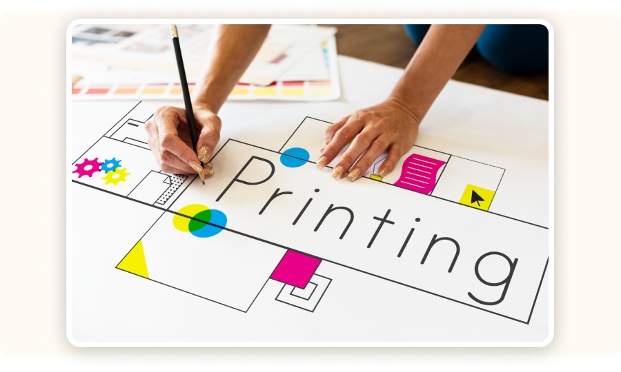 Close-up of hands working on a printed design&nbsp;