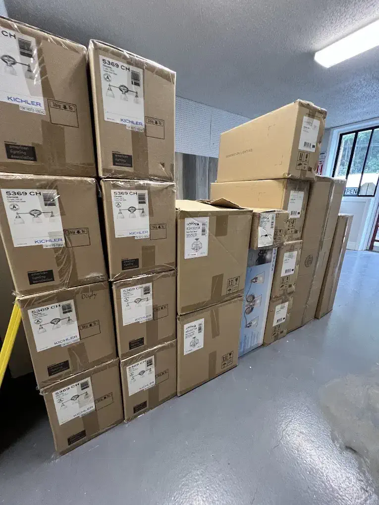 Row of stacked building supply boxes in warehouse