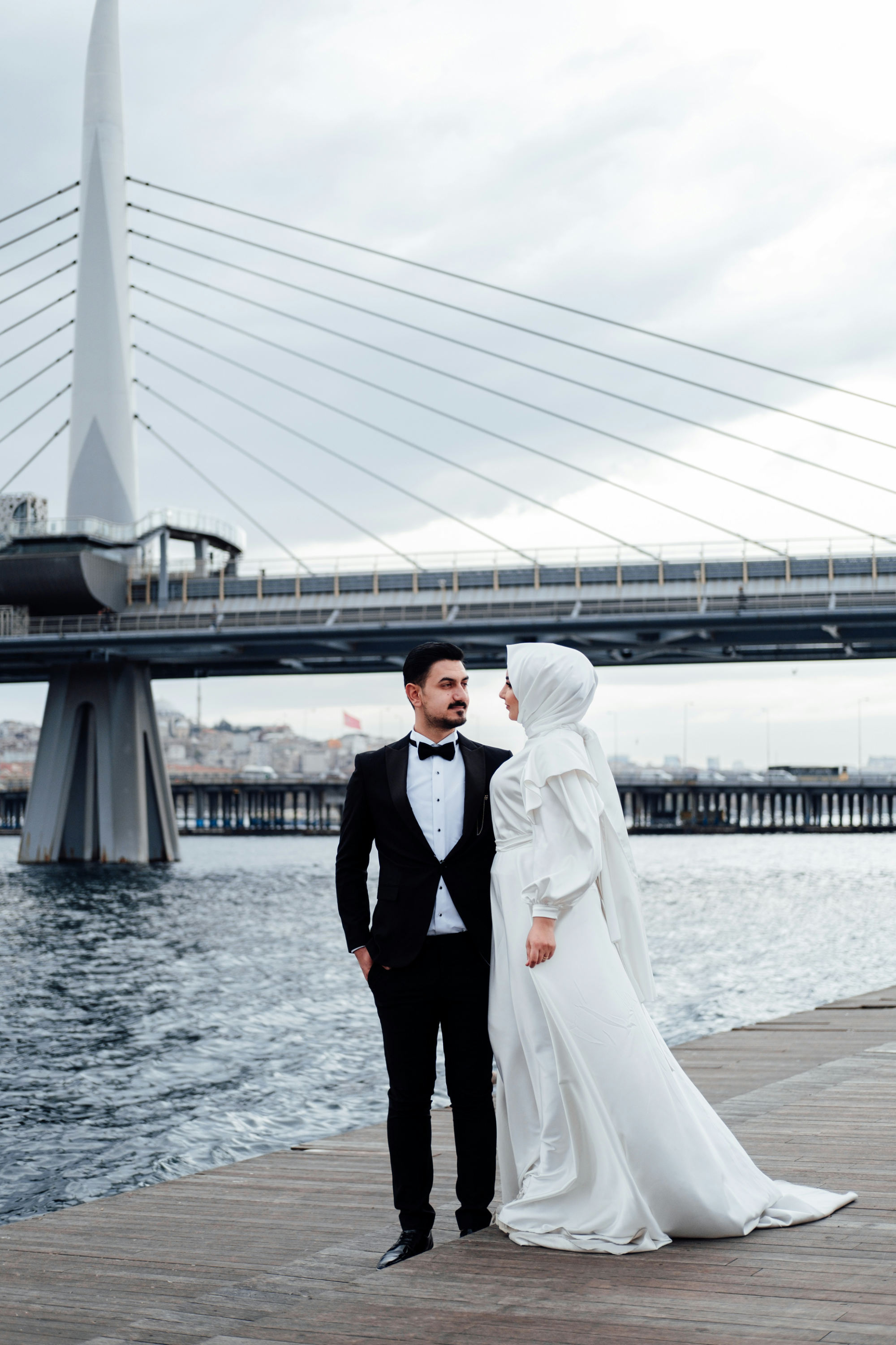 A couple next to a bridge