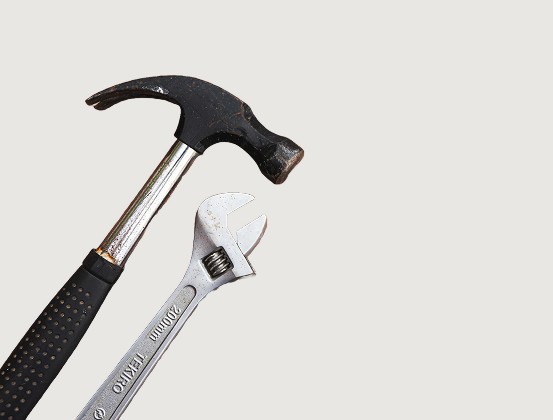 Hammer and wrench representing tools for small businesses