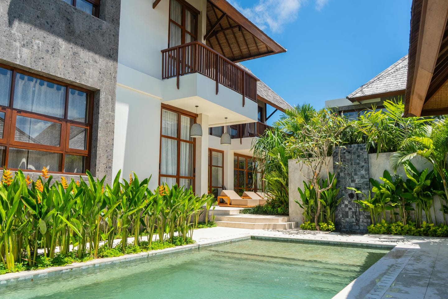 Minimalist white villa with sun loungers and pool at Nyanyi, curated by a professional property agent.