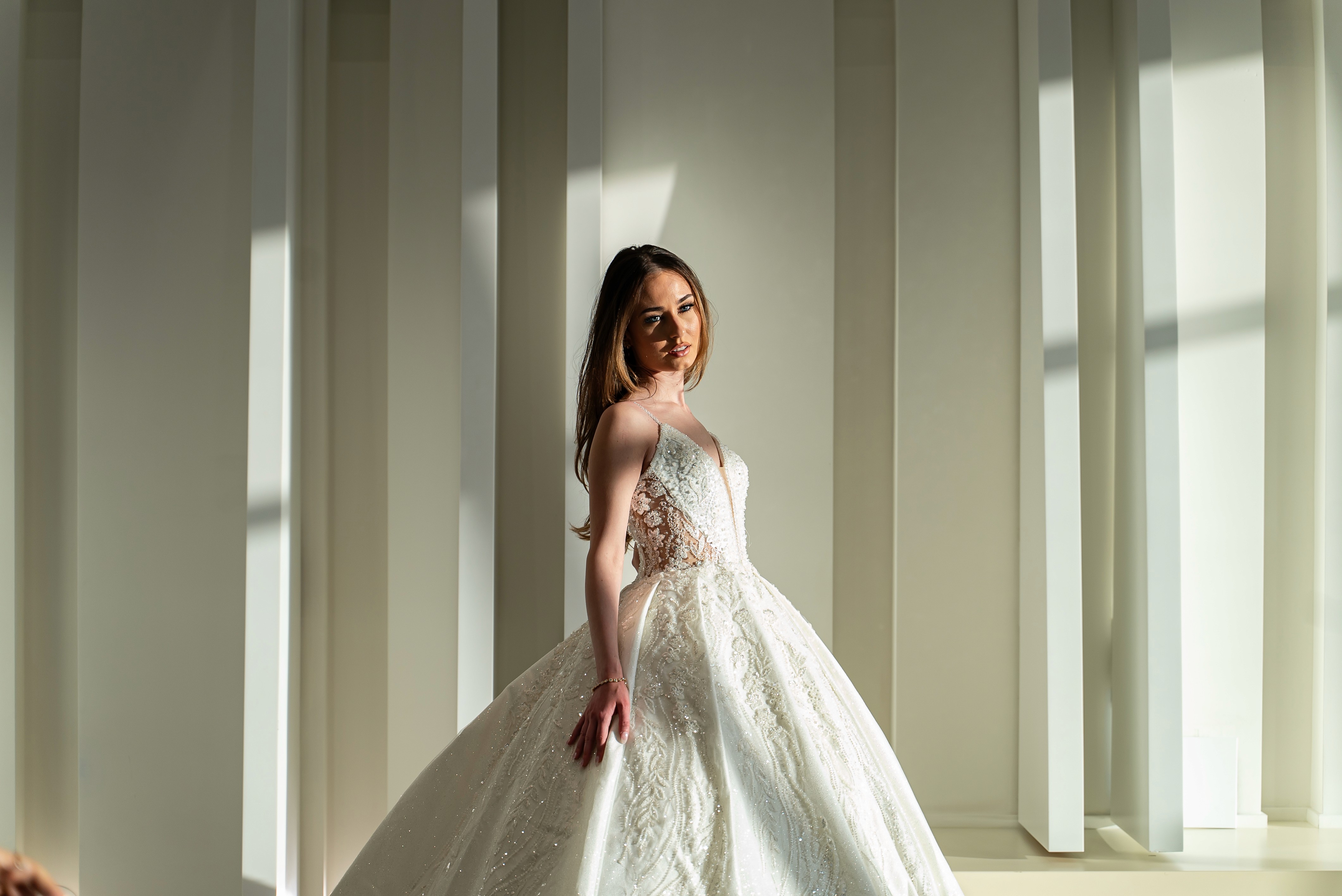 Celeste Fleur is a timeless couture gown, adorned with delicate floral appliqué and ethereal tulle, designed to embody elegance and romantic grace.