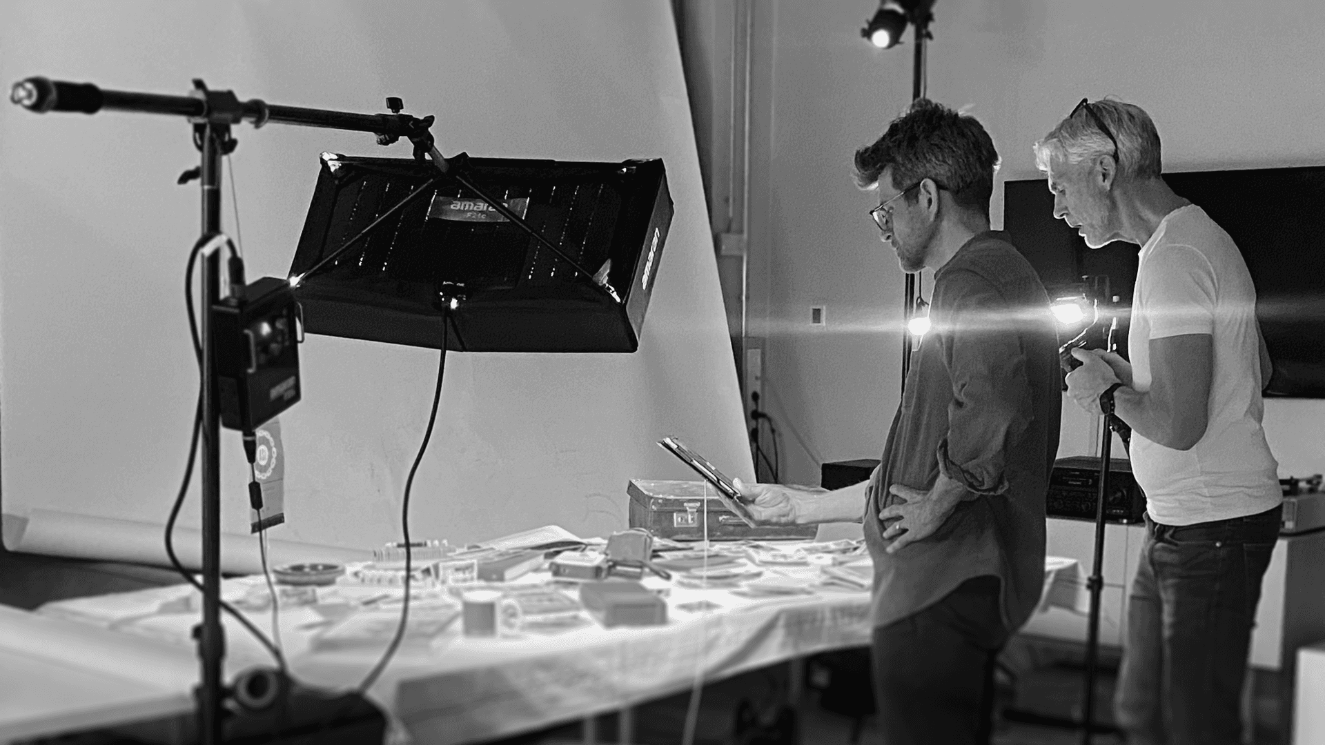 Four diverse professionals collaboratively working on a laptop, with one person pointing at the screen while others observe.