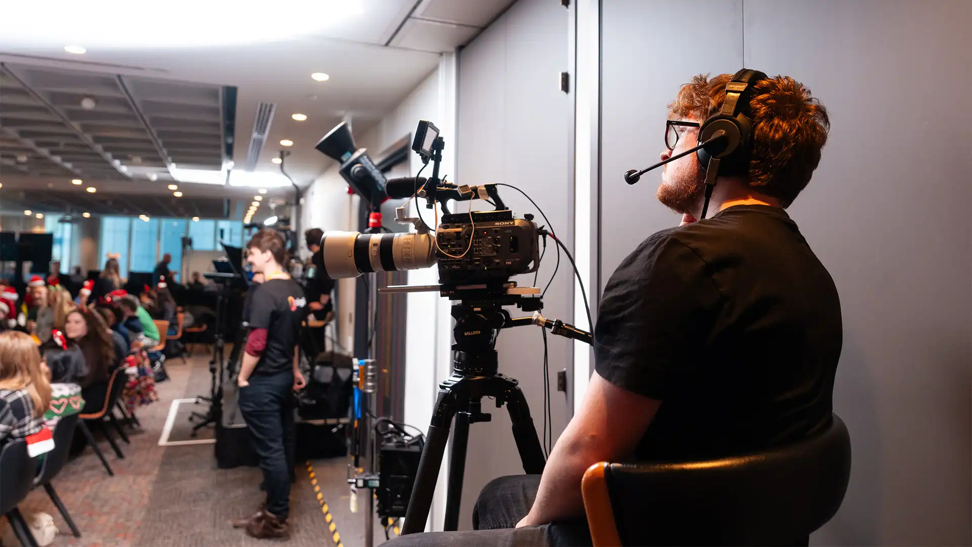 Camera operator filming a live Microsoft broadcast with a professional multi-camera setup.