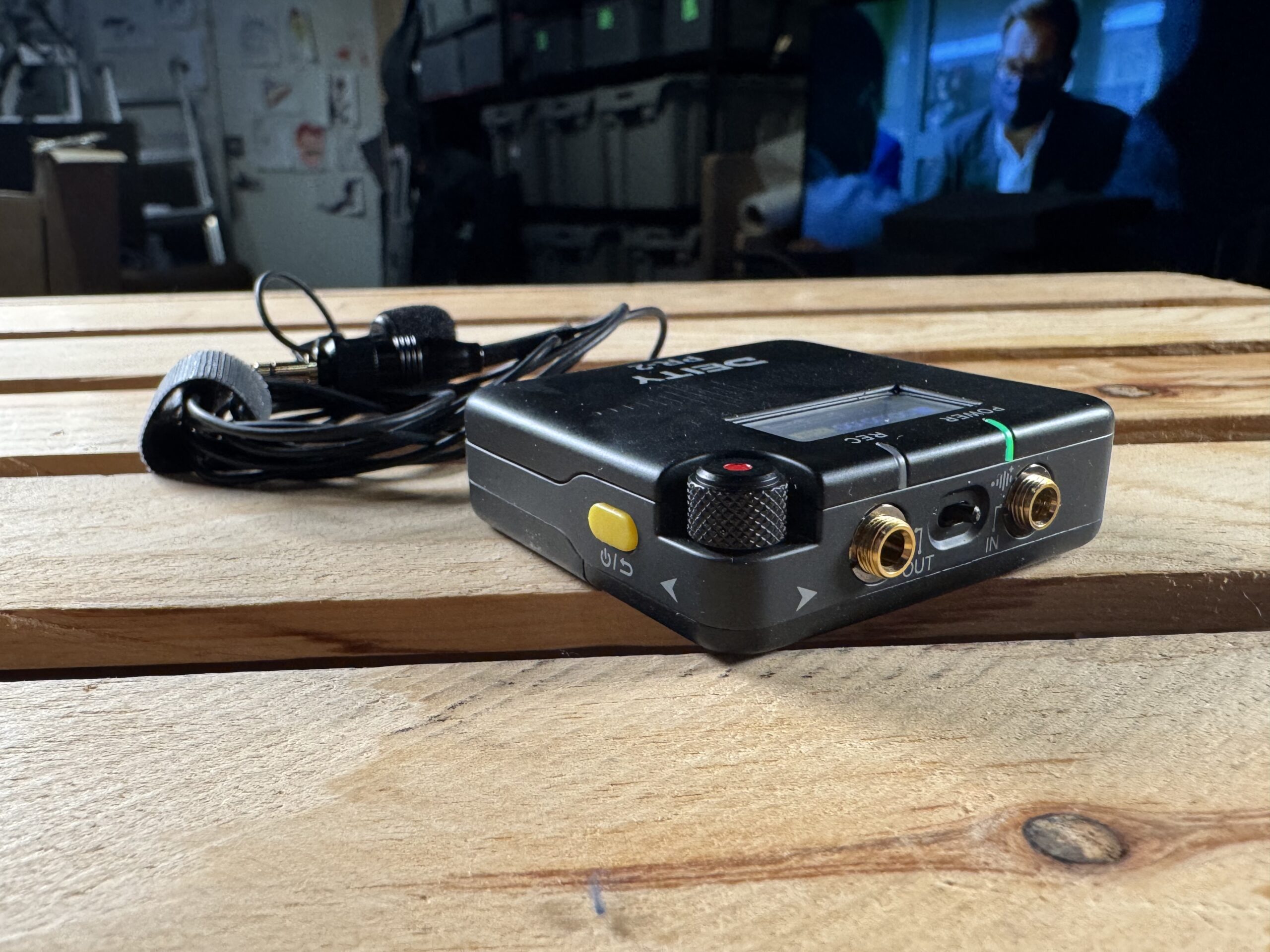 Side view of a Deity pocket audio recorder on a wooden table, highlighting its USB-C port.