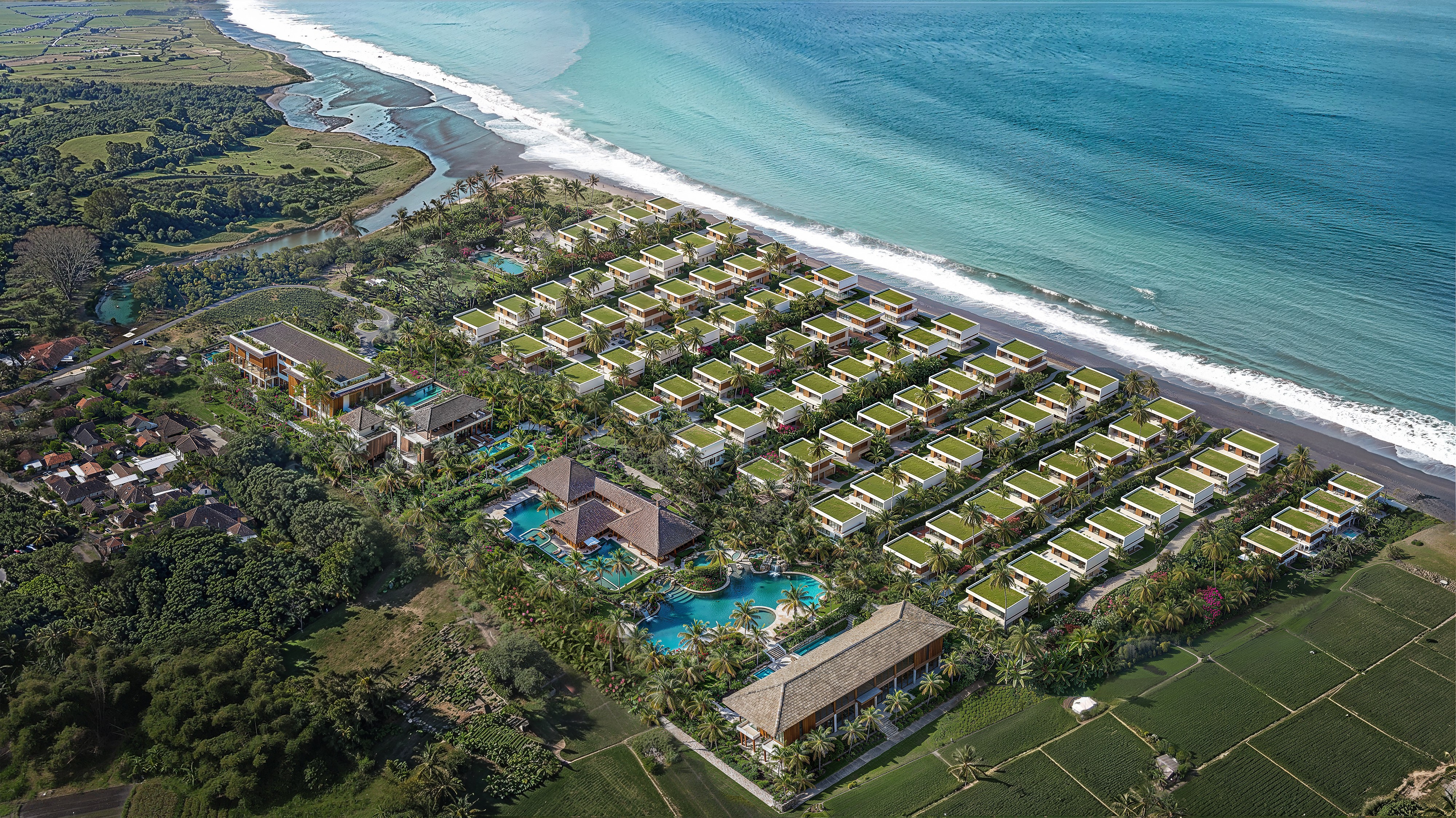 A man in a white lab coat working at a computer, viewing a 3D model on the screen in a laboratory or office setting.