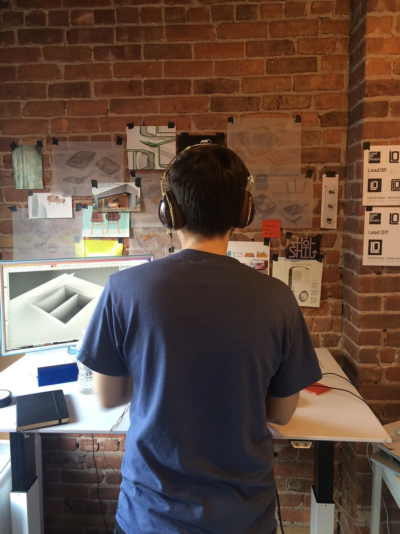 Designer working at a desk in Leadoff Studio's early Washington Heights workshop