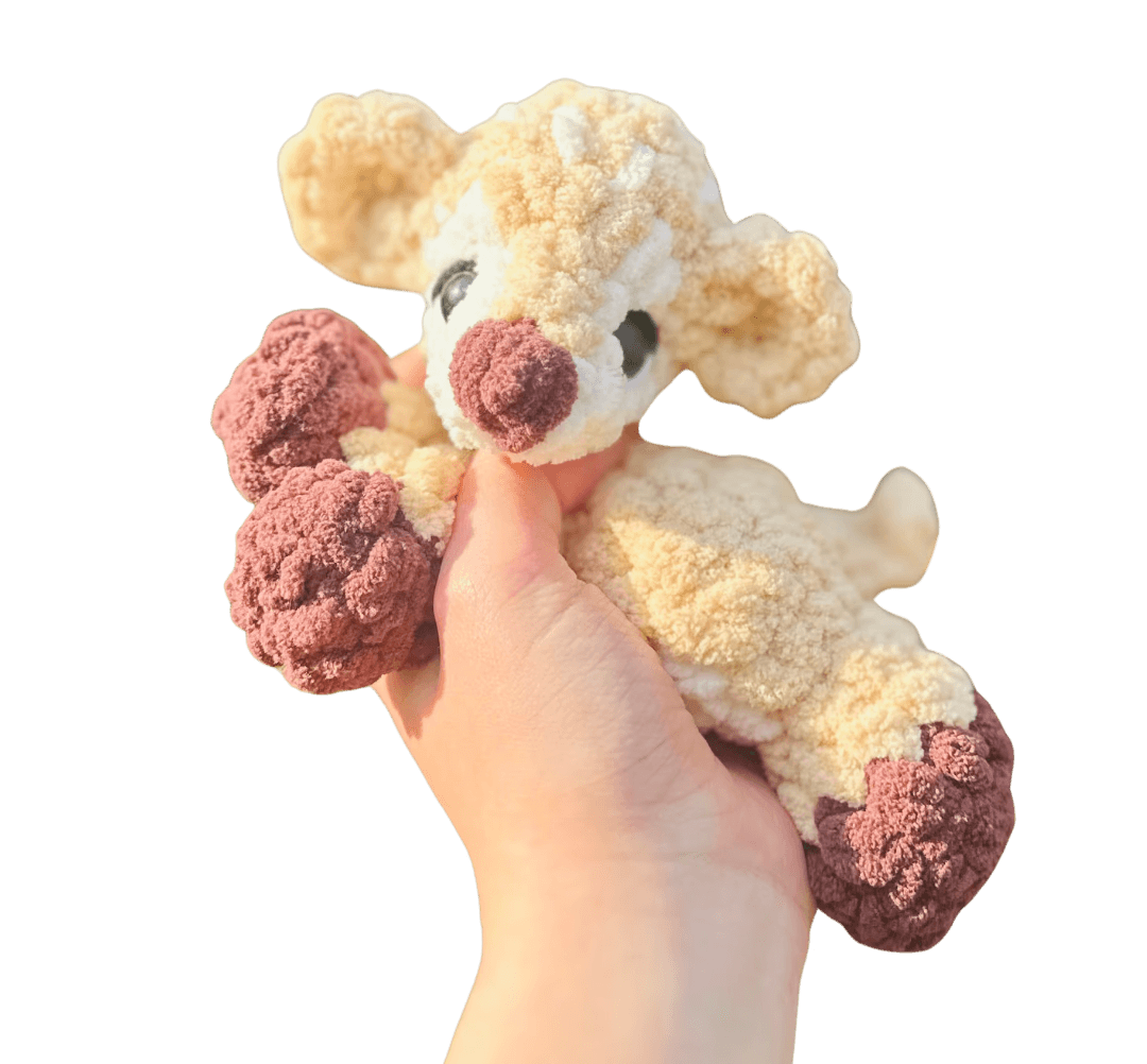 A cute, handcrafted plush acorn toy with brown yarn spikes and large, friendly eyes sits facing forward on a white background.