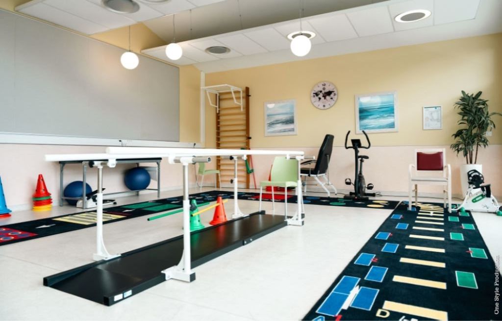 Physical therapy room with exercise equipment	parallel bars	and rehabilitation facilities
