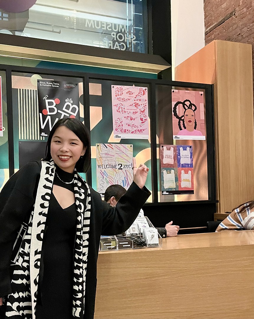 a womoan in front of a series of posters