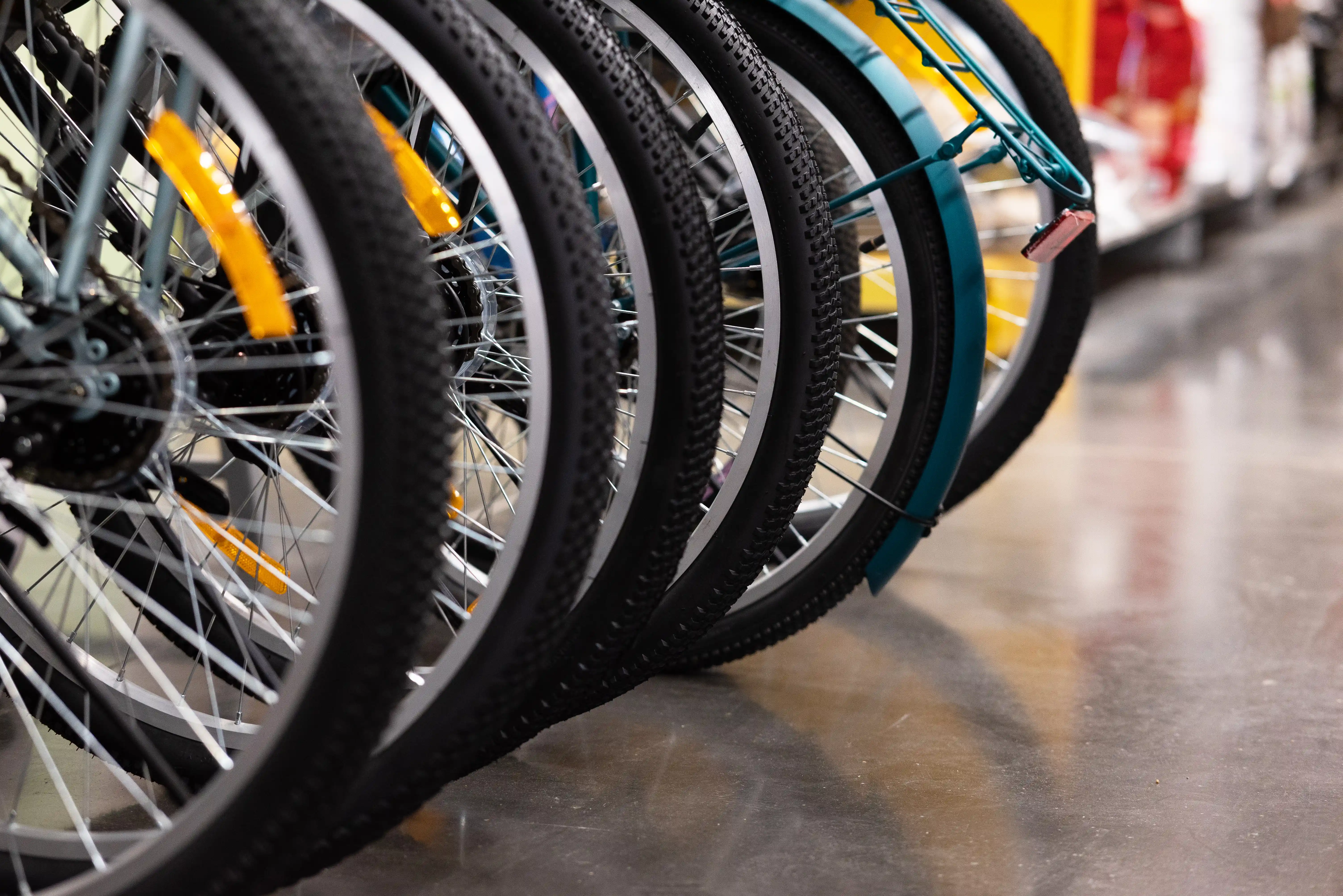 Close-up of bicycle wheels in a shop, representing a case study on rental bike mechanical failure and injury settlement