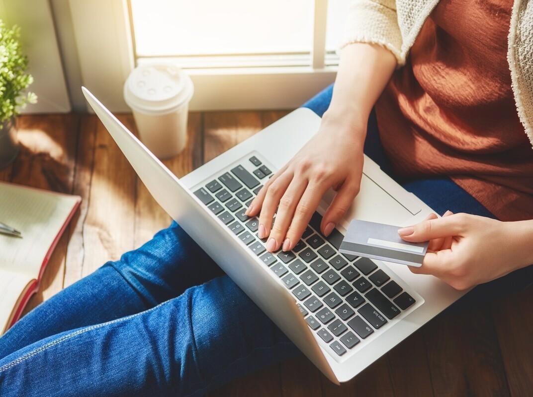 woman using her laptop to shop for equipment to use for exercises that help you lose weight