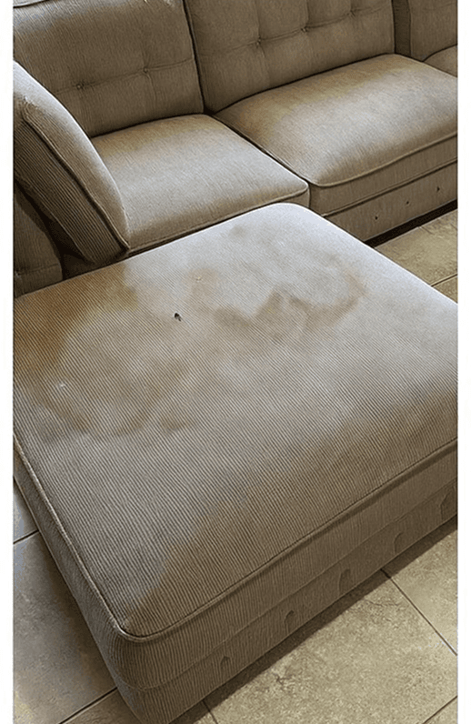 a person in white gloves is cleaning a chair