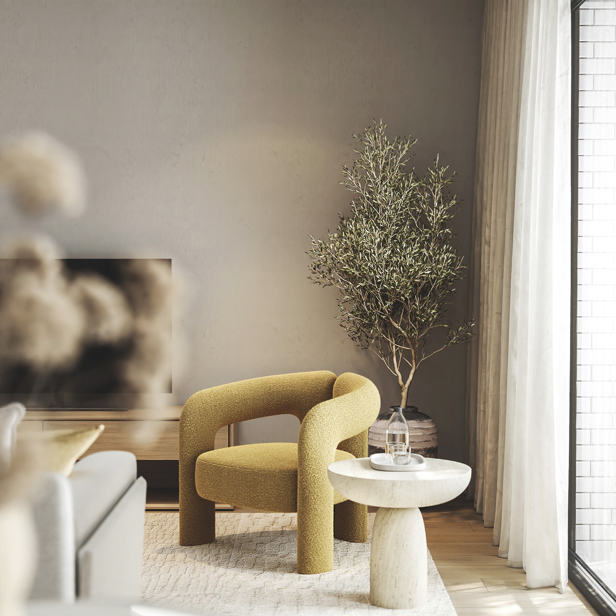A modern living room features a stylish mustard-yellow armchair from the Marvilla Collection sold by RE Sales, placed beside a small, round side table and a potted plant, all basking in natural light streaming through large windows.