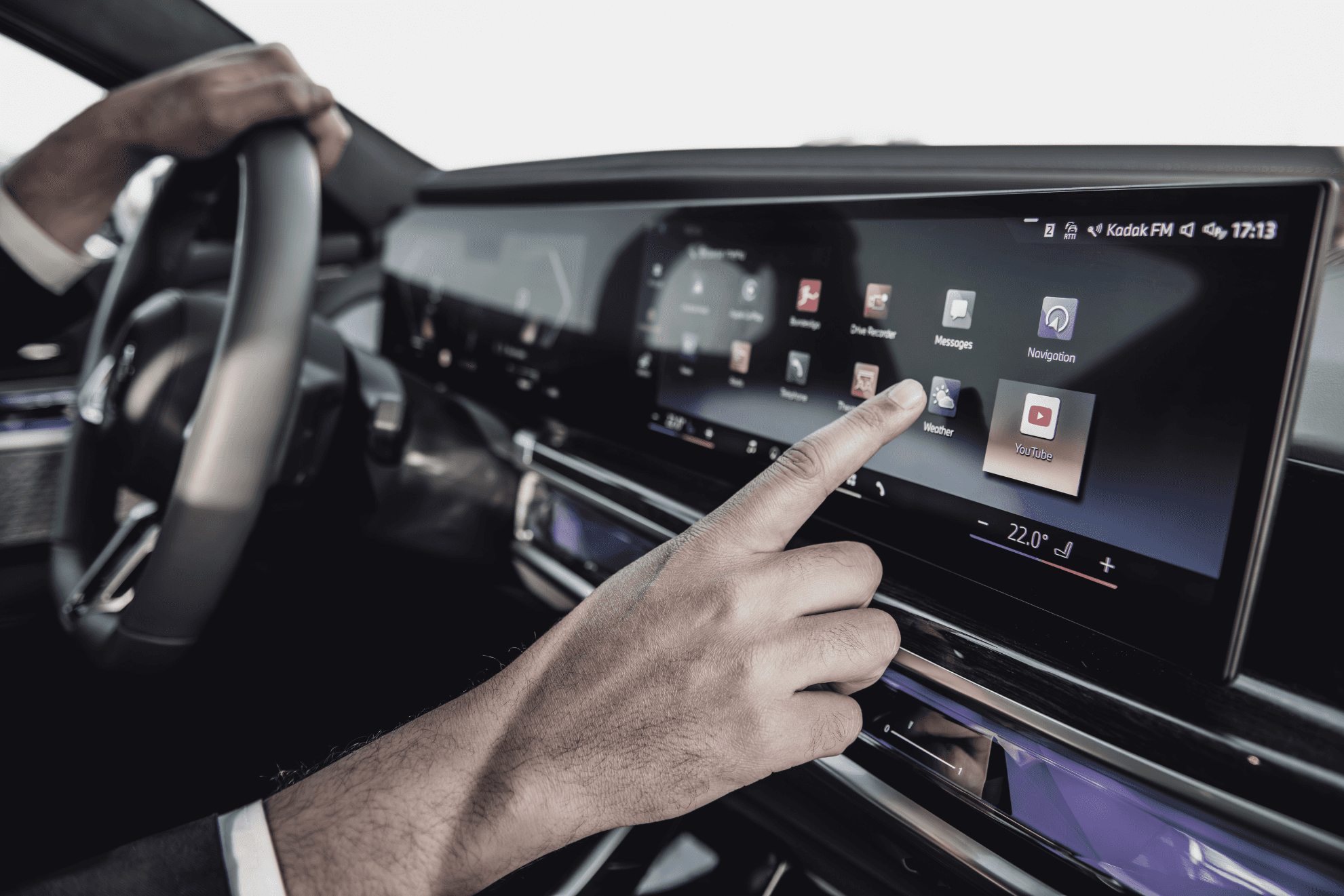 Chauffeur operating the advanced infotainment system of a BMW i7