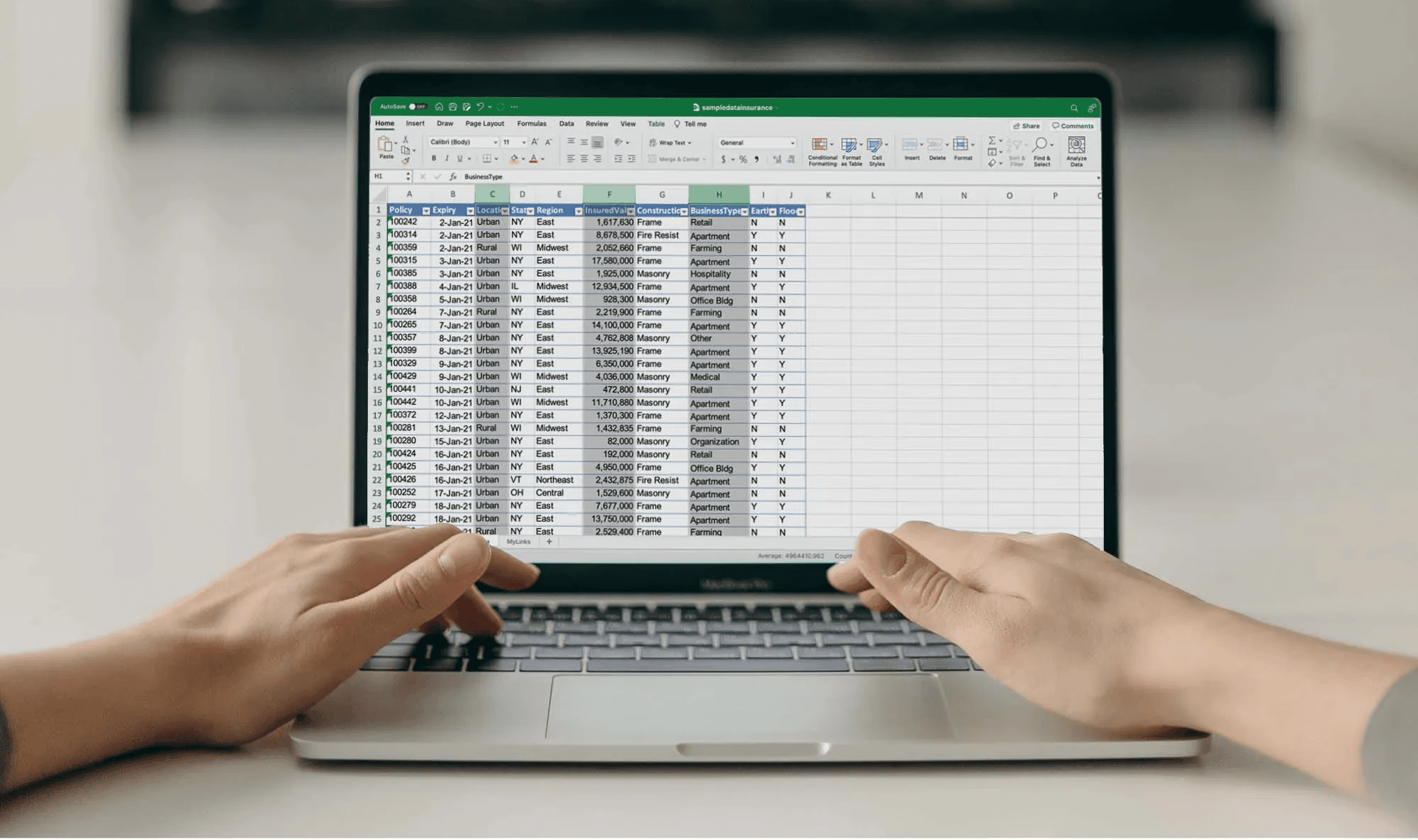  Person working on Excel spreadsheet - How to Automate Sending Emails From Excel