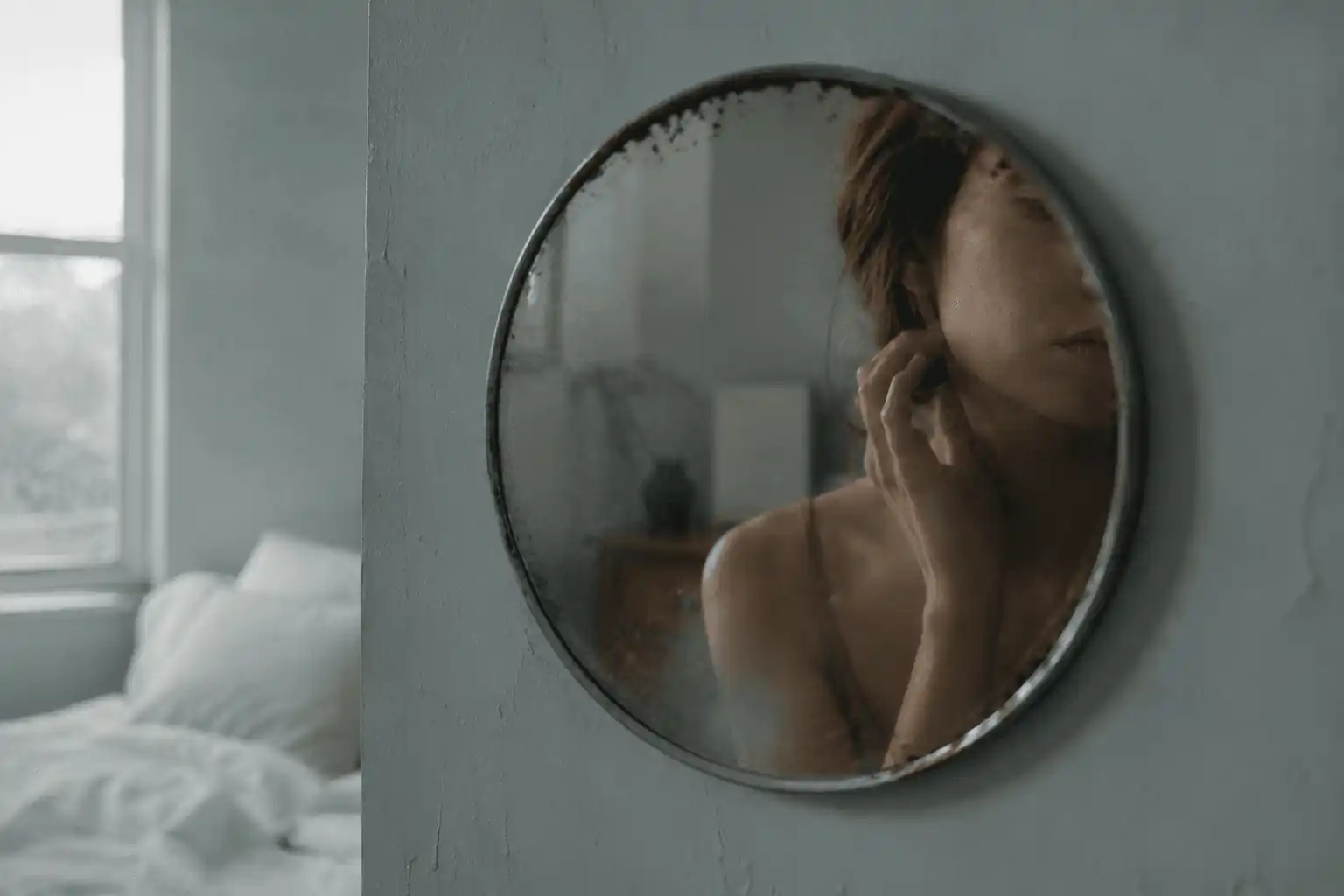 A softly fragmented reflection in a round mirror