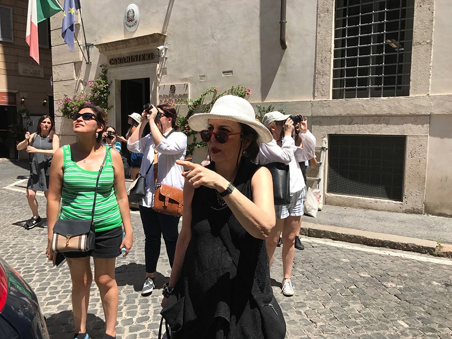 photo of tourists on the sidewalk