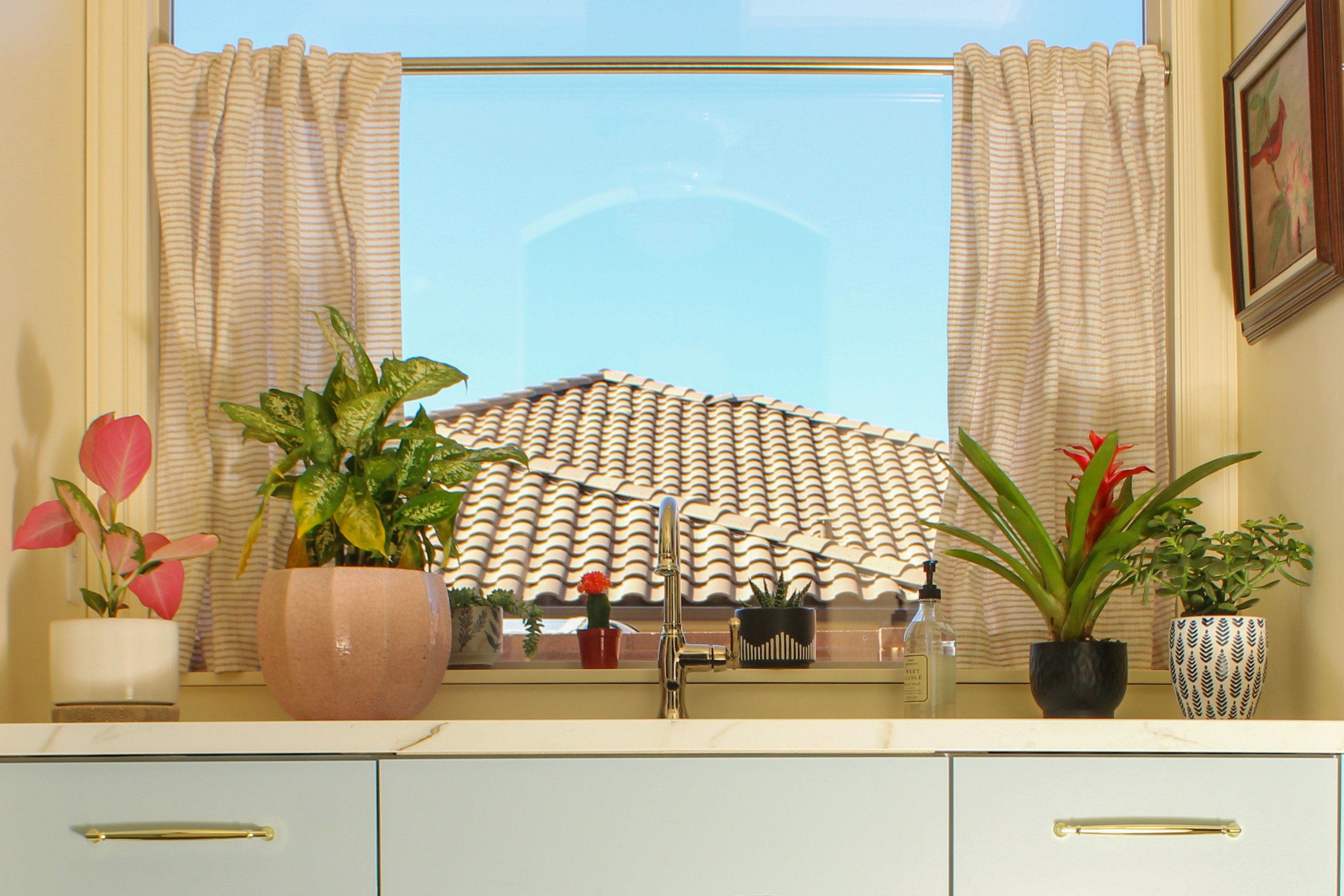 Kitchen sink area in a Washington, Utah remodel with window overlooking backyard and adjacent butler’s pantry