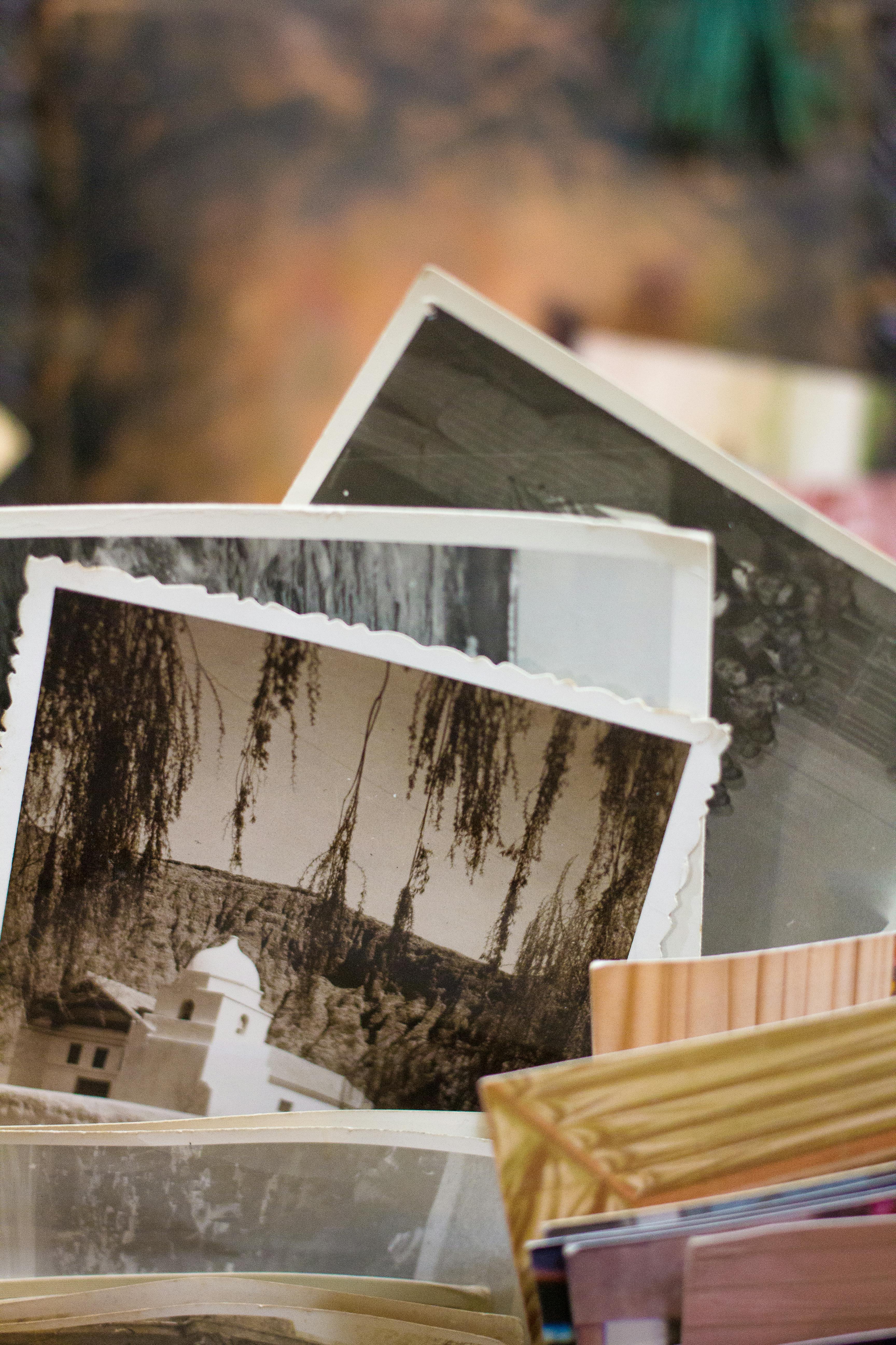 Stack of printed photographs spread across table