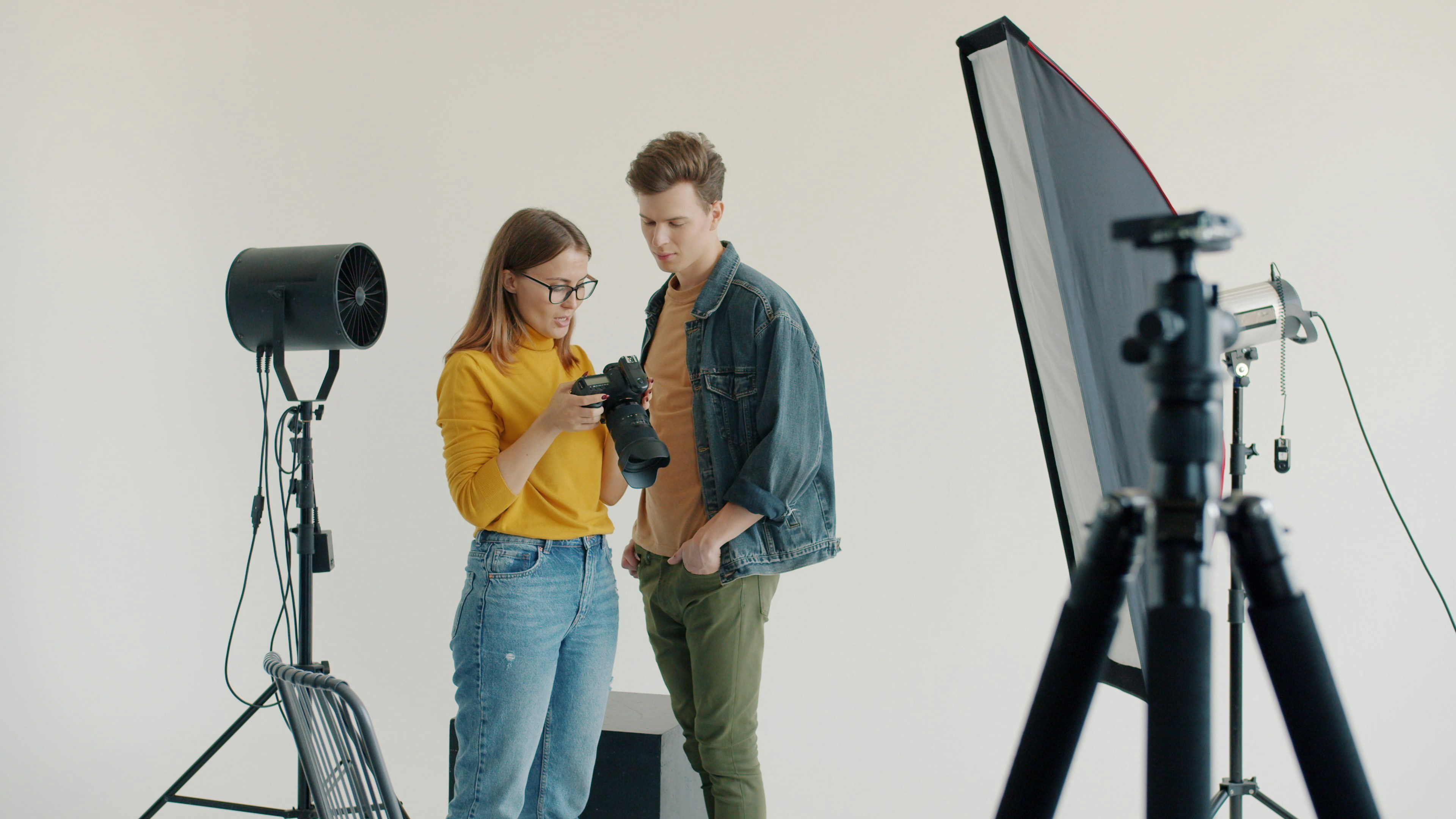 Two people looking at a camera in a studio.
