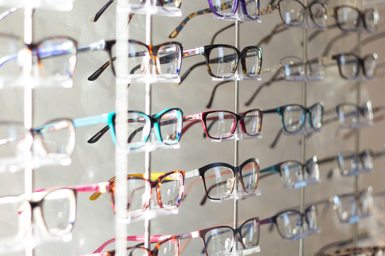 A rack of designer glasses frames in assorted colours