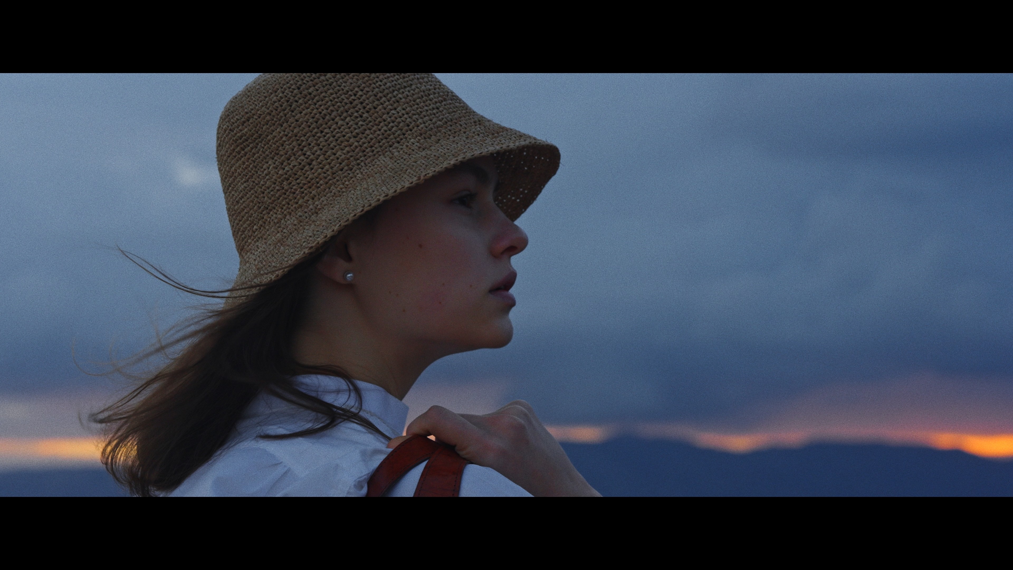 Front cover image for a short film made for Ibeliv. The image shows a woman looking off into a sunrise.