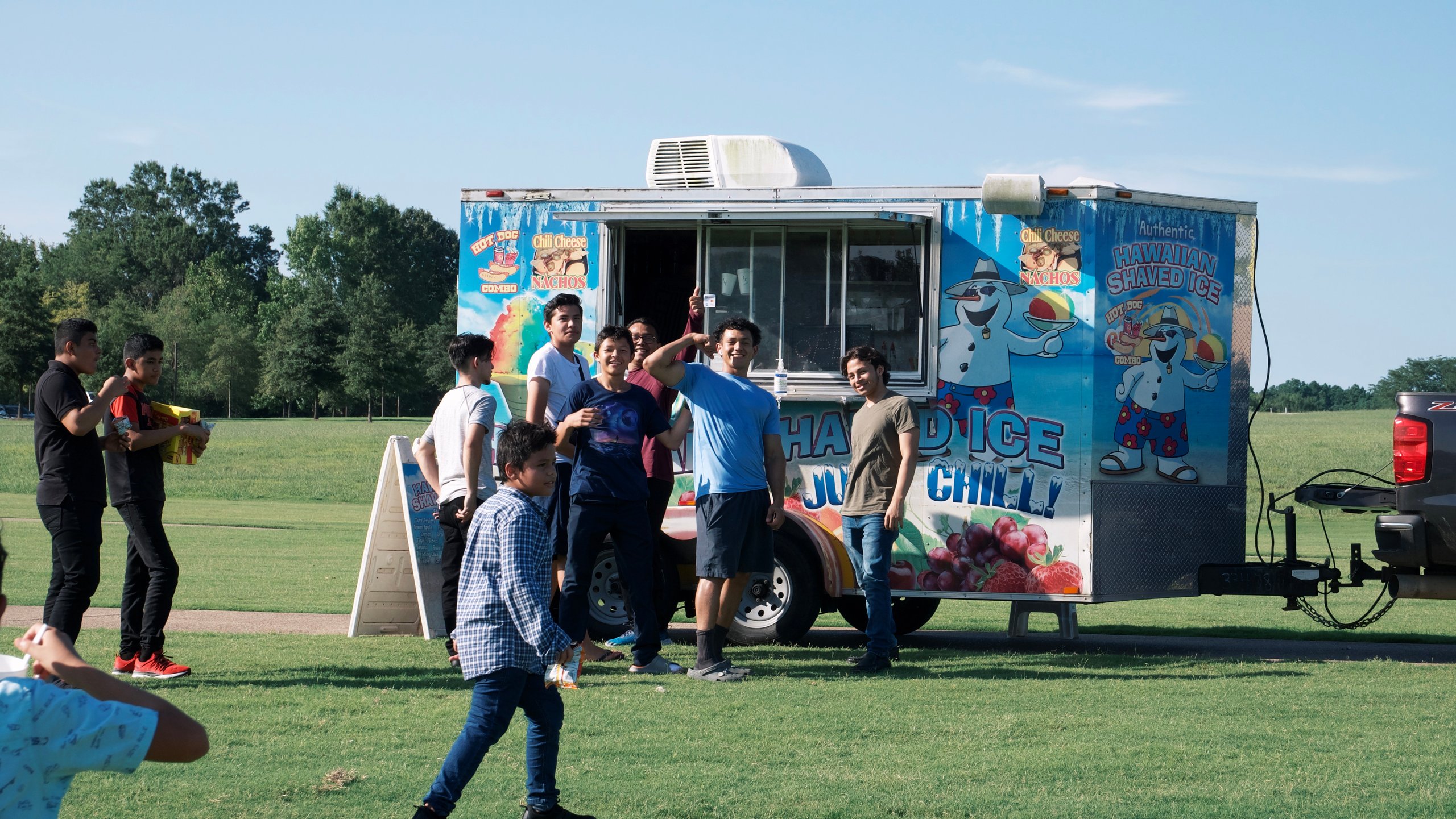 Kids and families gather at a food truck at the Pakistan Independence Day Festival