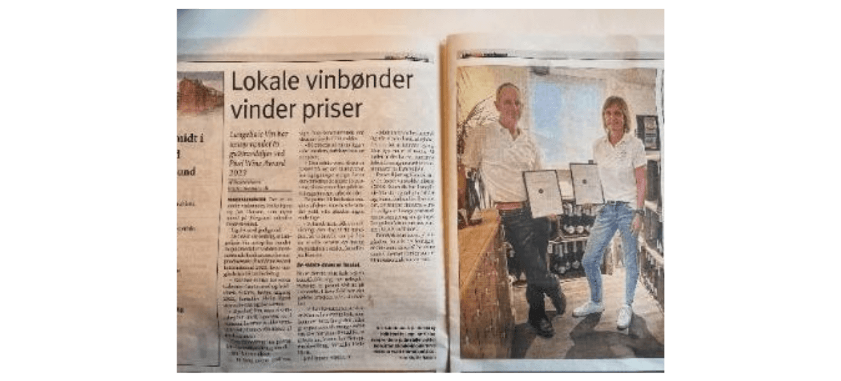 A newspaper with a picture of two people
Description automatically generated